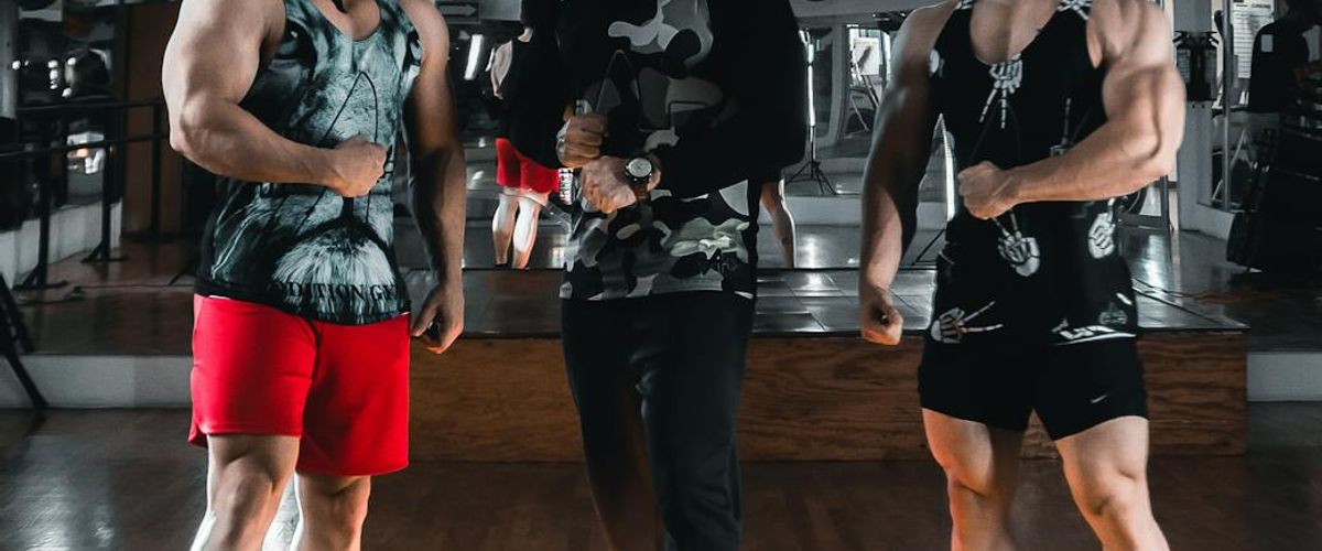 Group of determined men training with professional equipment